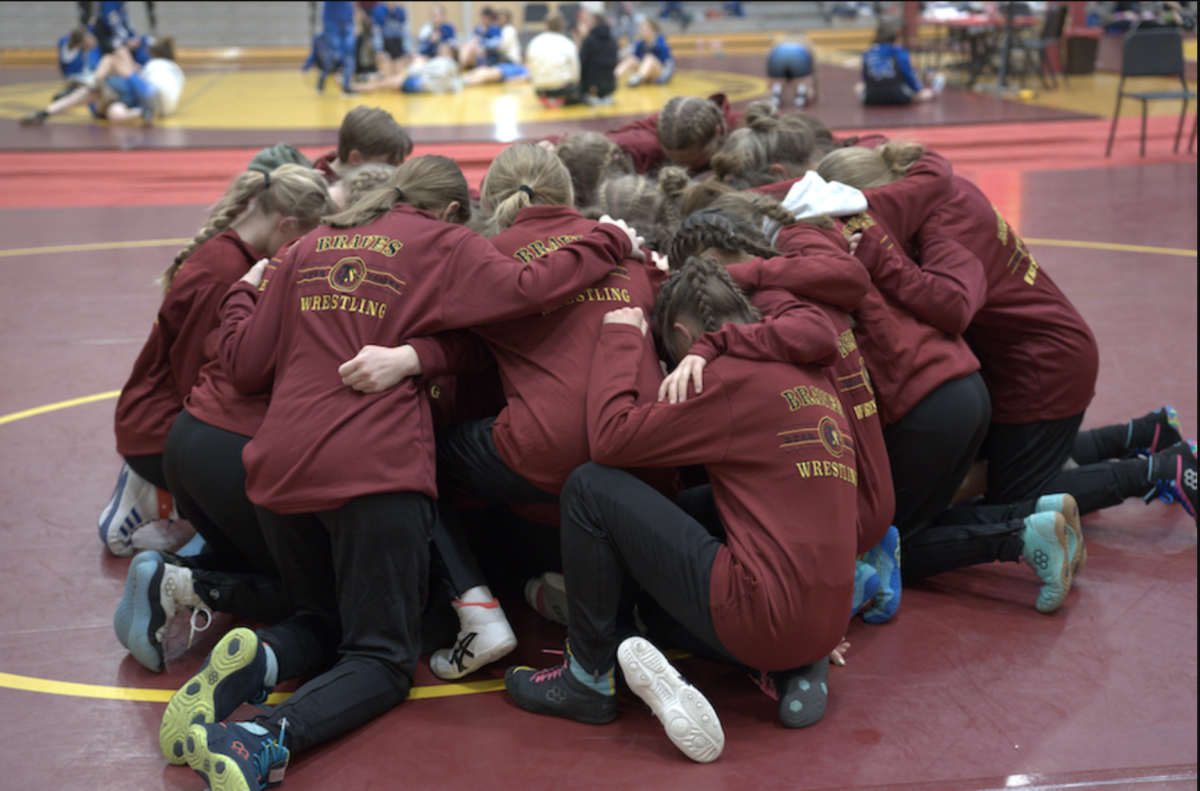 The Lady Braves gather together for a prayer before taking on their competition. Prayer is one of their biggest traditions before starting a tournament. Alexis Angell said "Our team is very supportive of each other, like you'll see at least five
girls on the side of the mat from our team cheering and yelling if one
of us is wrestling".    